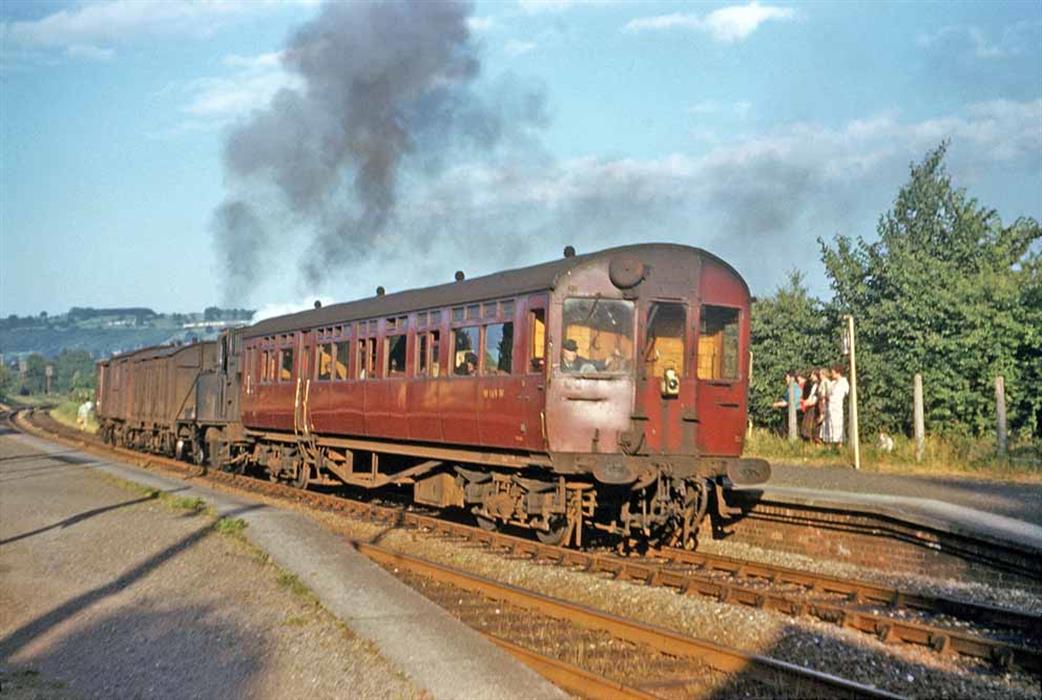 Another more unusual working is seen here, about to start away from Downfield Crossing Halt on Friday 16th June 1961, with an unknown '14XX' propelling trailer No. W169W whilst also hauling a 'Fruit D' and two fitted box vans almost certainly again filled with parcels. The time table suggests that the wagons had most likely been attached at Stroud. The long shadows caused by the lowering sun indicate that this is an evening service and the date is close to the longest day of the year, so we are probably looking at a time around 7.00-7.30pm. Two minutes were normally allowed in the time table for the call at Stroud but the 7.00pm return from Chalford stopped there at 7.131/2pm and stayed for 41/2 minutes, departing at 7.19pm; the extra 21/2 minutes are likely therefore to have been for the parcels vans to be attached or collected possibly from the goods loop on the Down side. No. W169W was a 59ft 6ins steel-panelled open trailer, built in January 1929 to Lot No. 1349. Its time in service was coming to a close when seen here, withdrawal taking place five months later in November 1961. John Strange/NPC
