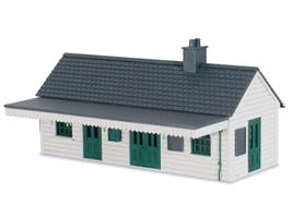 Peco OO LK-200 Wooden station building kit.Filling the gap for a wooden station building in the Peco OO gauge Lineside Kits range this building is a typical locally constructed wooden structure as could be found at wayside stations on cross-country routes and branchlines. The generic in design represents a structure with horizontal wooden boards, and can be built with or without the canopy.This is a mixed media kit with wood and plastic parts. The main structure including floor and walls have been produced from MDF, laser cut and engraved with planking lines. Moulded plastic window frames, roof tile sheets and detailing parts are drawn from Pecos' existing kits and LK-78 and LK-79 building detailing sets. Assembly is very straight forward as the clear exploded diagrams on the instructions guide the builder through each stage. The laser cut detail of the canopy brackets are particularly eye-catching. Being a generic model intended to recreate a locally built wooden structure the kit can easy be modified to create a sports pavilion, large shed/workshop, office building for a coal, builders or timber merchants' yard or even a beach cafe of the type found alongside many seaside promenades.