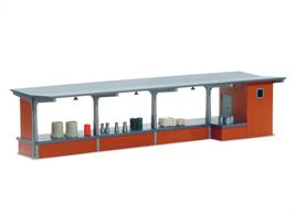 Goods Depot Kit. An easy to assemble correct coloured moulded plastic kit to build a modern concrete and brick type goods depot or loading bay. 309.5mm long. It provides covered loading and unloading facilities between rail and road. Various accessories are included in the kit for use as wagon loads or to add interest to the platform. the actual selestion may vary.
