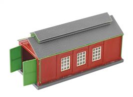 This Peco kit builds up into an attractive single track country type engine shed. Moulded in plastic with brick red walls grey roof and green doors. Area: 114mm x 51mm