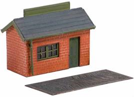 Many goods yards had weigh bridges so that the 'carriage price' of a load to be carried by rail could be costed. Goods were then loaded into the goods shed. Kit includes guttering, brass etched scales and weighing plate, barge boards, window and door; glue and paints required to complete this model. Footprint: 30mm x 15mm.