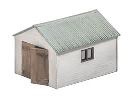 Timber style garage to store a single car. Supplied with pre-coloured parts although painting and/or weathering can add realism; glue is required to complete this model. Footprint: 68mm x 56mm.