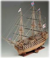 The hull is double planked in limewood and walnut, with tanganyka strips for planking the deck. All wooden parts are pre-cut to facilitate assembly. Lanterns, railings and other fittings are brass, gilded cast metal and walnut. One hundred cast metal cannon and carronades are burnished for an authentic appearance. Brass gunport frames open and close with hinged lids. Display stand, five diameters or rigging, flags and hammock netting are provided. Fourteen sheets of plans plus an instruction book including directions for building the admiralty version guarantees a faithful replica. Scale 1:98, Length: 1035mm.Skill Level 3