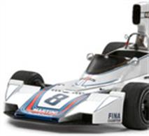 1/12 assembly kit of the 1975 Martini sponsored Brabham BT44B. This model has been produced to celebrate the 50th anniversary of Brabham racing. Length: 355mm, Width: 162mm, Height: 106mm. Photo-etched parts included to depict details such as the radiator, wingtip panels, brake discs and metal parts for seatbelts. Cloth texture seatbelt stickers included. Movable suspension incorporates coil springs. Working steering wheel is linked to the front wheels. Highly detailed DFV engine includes fuel pipes and ignition cables.Front fairing, cockpit fairing, and induction box are detachable. 2 kinds of Cartograf decals are included to depict the cars that won the Brazilian and German GP.Glue and paints are required