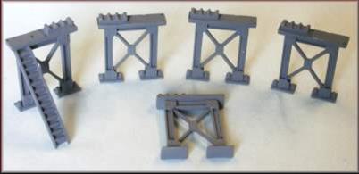 Pack of 5 heavy construction supporting girder 'legs'&nbsp; cast in whitemetal designed to provide clearance for N gague trains to pass beneath. Supplied with pipe racks and access steps for use as pipe bridge supports.