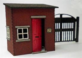 Laser cut wood kit building a model of a small brick yard office or gatehouse with gates.
