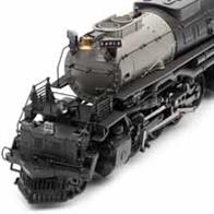 Detailed model of Union Pacific 4000 'Big Boy' class 4-8-8-4 articulated locomotive number 4014 finished UP Steam Heritage form with fuel tender.The Union Pacific Railroad ordered 25 of these 4-8-8-4 articulated locomotives from the American Locomotive Company (ALCO) to haul the increasingly heavy freight trains over the Sherman Hill route during WW2. While on the shop floor someone chalked 'Big Boy' on the huge new locomotive being assembled. While not the largest, heaviest or most powerful locomotives the UP 4000 class balanced these features with the speed needed for fast freight service.4014 was reacquired by the Union Pacific in 2015 and restored to service as part of the UP Steam Heritage programme to mark the 150th anniversary of the completion of the transcontinental railroad.With a confounding length of 475mm (almost 19 inches), a 5-pole motor and brass flywheel, a DCC Ready 21-pin plug, handrails made from steel wire and much more, this locomotive is unlike any other and undeniably lines alongside other models as a classic.