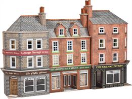 Low relief high street buildings featuring a corner pub and a row of two shops.