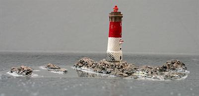 A 1/1250 scale resin model of the Les Pierres Noires lighthouse and the associated rocks. The fully painted castings are mounted on a clear, transparent film to represent the lighthouse at low tide.