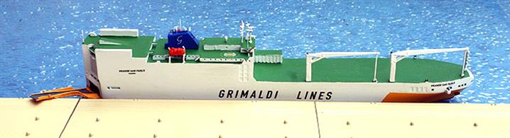 A 1/1250 scale waterline metal model of Grimaldi Lines Grande Africa class Ro-Ro ship Grande Amburgo (IMO 9246607). The model is made by Rhenania and has interchangeable parts (loading ramp &amp; door) for port dioramas. The photograph shows the ramp lowered for loading. There is a deck load of cars and containers, see Rhe186Z