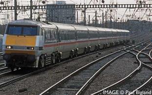 The electrification of the East Coast Mainline occurring in 1987 was almost complete, with deliveries of new electric Class 91s occurring when British Rail realised the Mk4 coaches and Mk4 DVT were still not ready to go into service. As a result, eight eastern region HST power cars were converted to operate as surrogate DVTs in tandem with the new electric locomotives and a rake of Mk3 coaches. The conversion process involved the fitting of buffers and remote-control equipment.