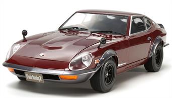 This model recreates the Fairlady 240ZG, released in Japan in 1971, fitted with a host of tune-up parts typical of the era. 1/12 scale. Length: 356mm, width: 151mm, height: 101mm. Features recreations of RS Watanabe 8-spoke wheels. The powerful straight-6 engine is depicted with triple carburetors and metal air funnel parts, photo-etched carburetor insulation pieces, plus a strut tower brace. A clear engine hood is also included. The realistic interior includes accurately recreated roll bar, plus a choice of standard or bucket seats. Photo-etched parts depict buckles on the bucket seat racing belts. Opening doors, engine hood and tailgate parts. Moving suspension. Front wheels move in tandem with steering wheel operation. Includes parts to recreate rear spoiler.