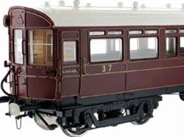 A highly detailed model of the GWR diagram N driving trailer or auto coaches built in 1907 to diagram N numbered 37 to 41. These wood bodied coaches featured the panelled construction of the period which Dapol are faithfully reproducing, along with fully detailed interior including driving cab with controls and saloons with their mix of side bench and cross seating bays. The underframe carries retractable steps, brake fittings and gas reservoirs for the lighting, complemented by detailed reproductions of the GWR 'American' bogies with their prominent drop-equaliser beams.This model is finished in the GWR lined crimson lake livery of the 1912-1922 period.