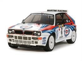 This is a 1/10 R/C model assembly kit of the Lancia Delta Integrale. The polycarbonate body recreates the look of the angular 4-door hatchback, complete with front/rear blister fenders and down to details such as the bulge on the front bonnet and the numerous air intakes in the front bumper. The kit also includes separate parts to depict the side mirrors and roof spoiler. Stickers recreate the markings, including the famous Martini Racing stripes. The model runs on the front motor, belt-driven 4WD XV-01 chassis, and comes complete with rally block tires to make it ready to drive on-road or on flat dirt.