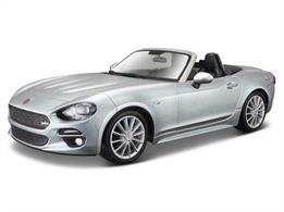 Diecast model of a 1:24 scale Fiat 124 Spider that has been recreated in meticulous detail. The exterior displays all of the slick curves and sweeping lines of the original, whereas the interior shows the same high attention to detail, featuring carefully crafted replica upholstery. The chassis is finished with an electrostatic paint coating, giving it the ideal final touch.